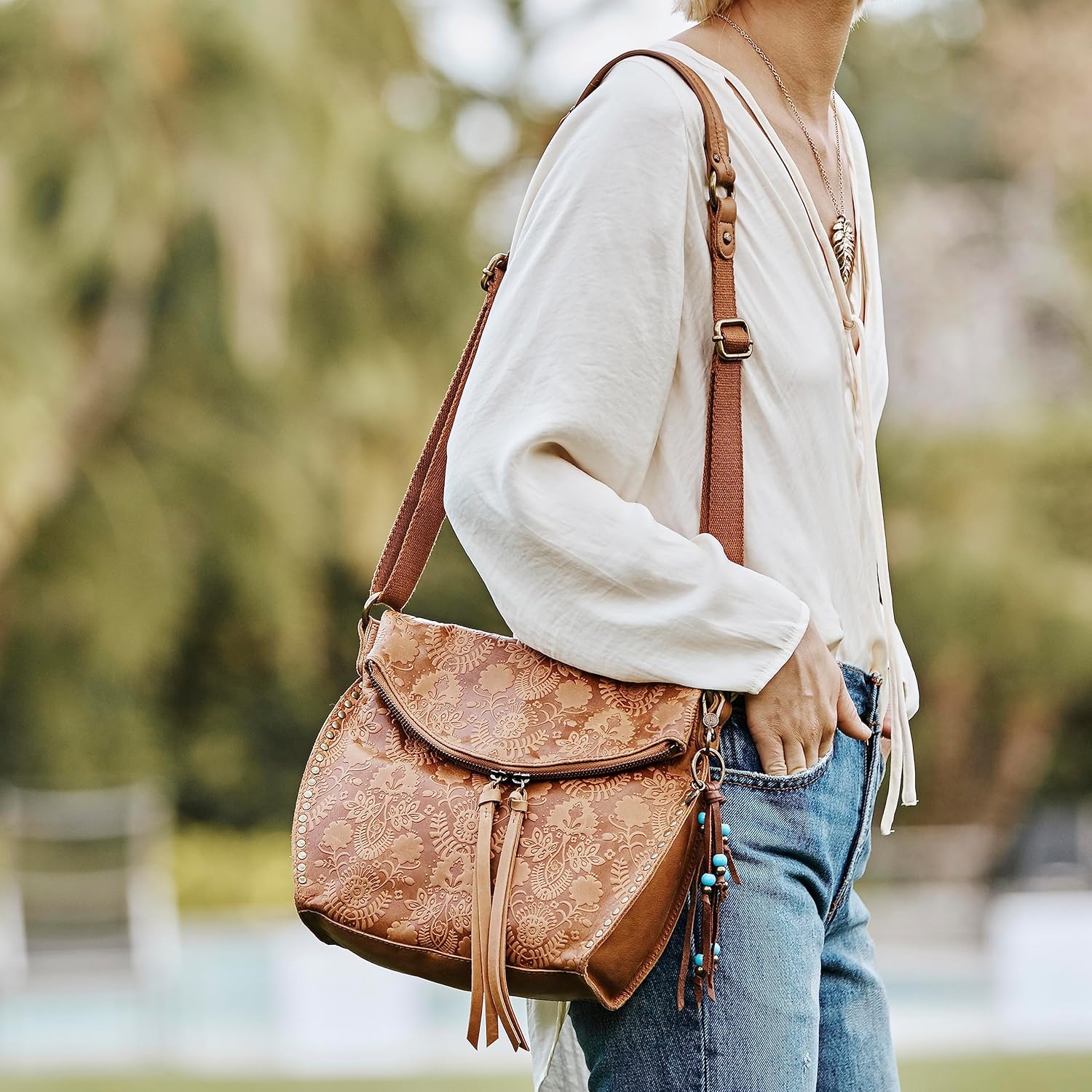 The Sak womens Silverlake Crossbody Bag in Leather Casual Purse with Adjustable Strap Zipper Pockets, Tobacco Floral Embossed Ii, One Size US